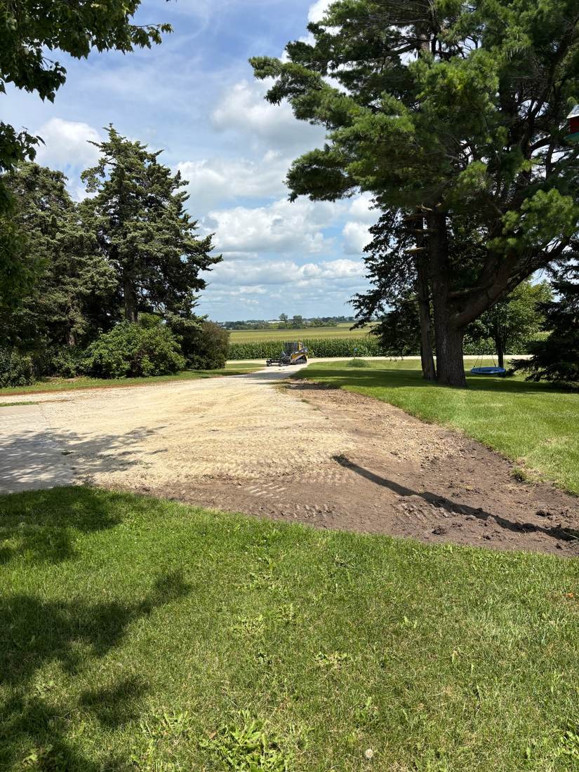 Circular driveway before revitalization, worn and patchy, angle one