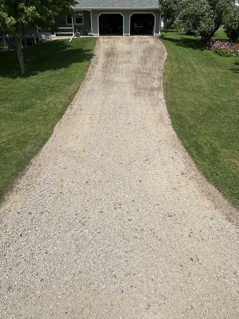 Two-car garage driveway after revitalization, fresh even gravel