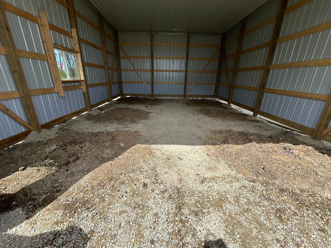 Uneven dirt and gravel floor before grading