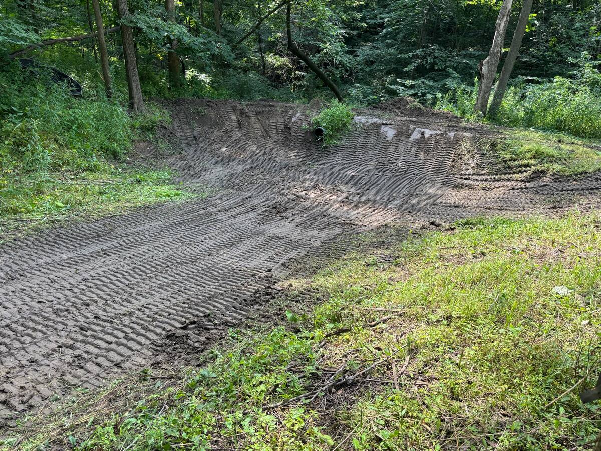 Freshly excavated retention pond basin on a hunting property, graded and ready to fill